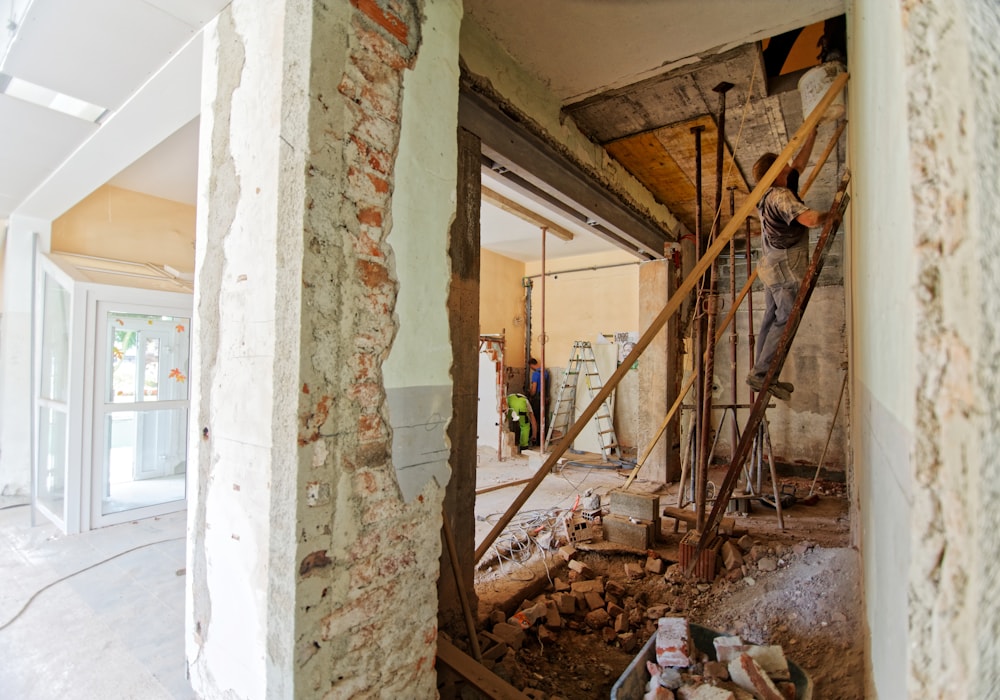 A room mid-renovation with exposed brick, props and ladders